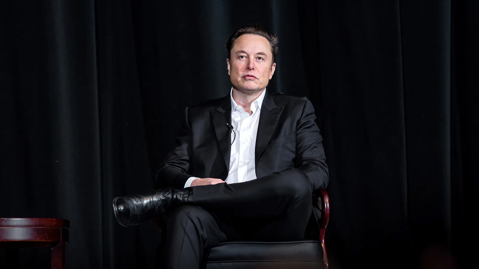 Elon Musk seated on a stage at the United States Air Force Academy in April 2022