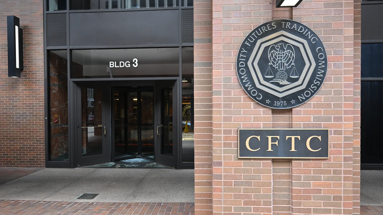 Entrance of the Commodity Futures Trading Commission in Washington with the agency's name and seal on the wall