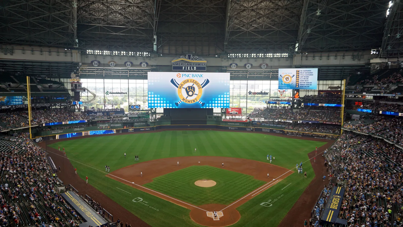 The roofed ballpark of the Milwaukee Brewers seen from the upper deck, the diamond and stands filling before a game